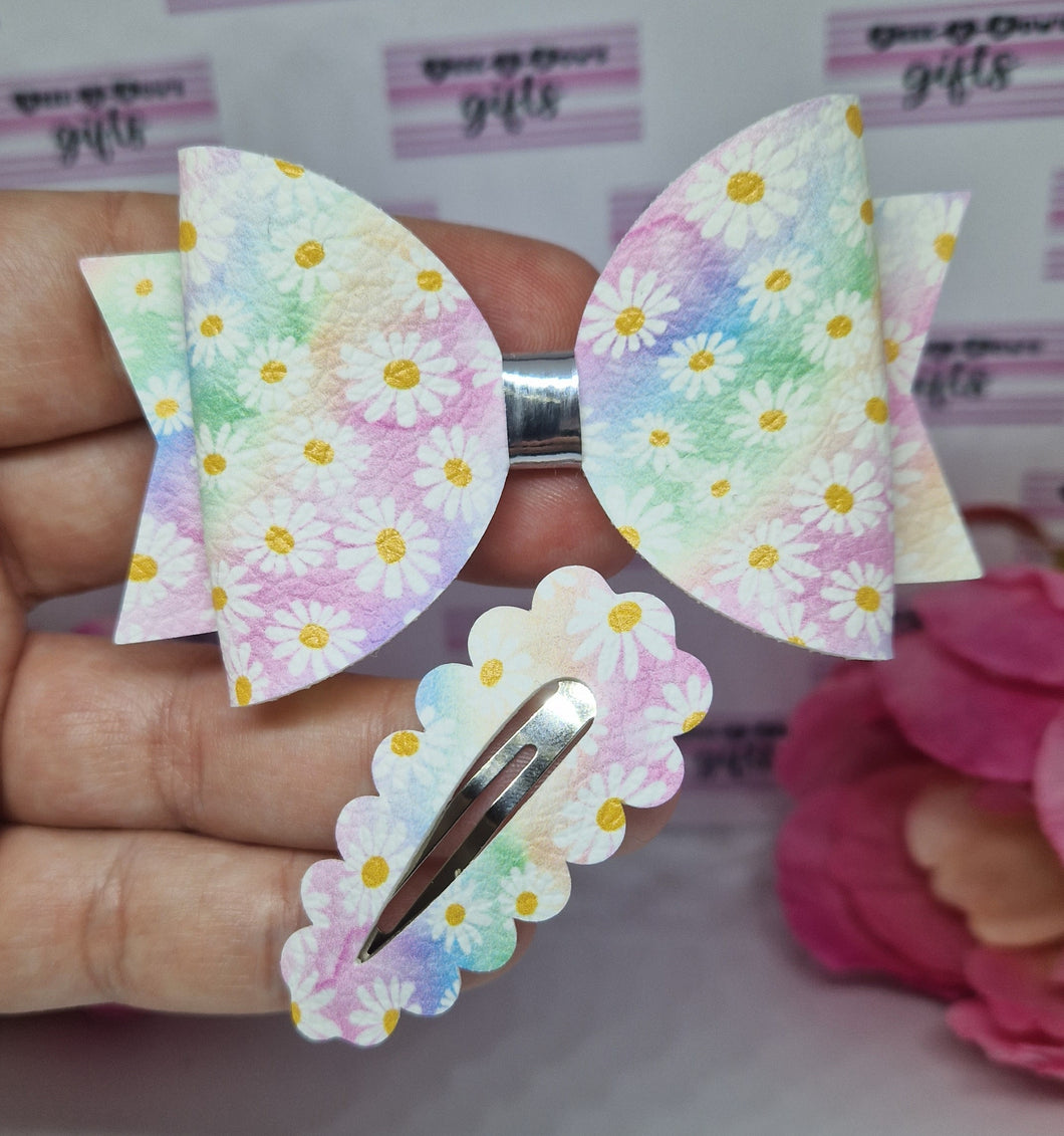 Rainbow daisy bow and snap clips.